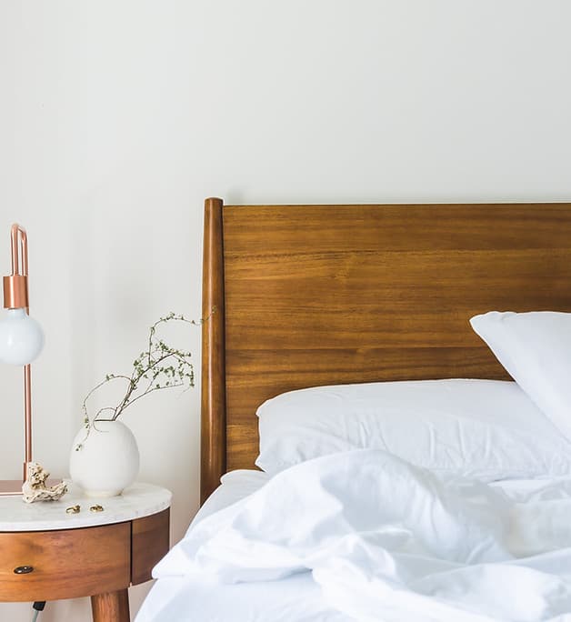Wooden bed with pillows